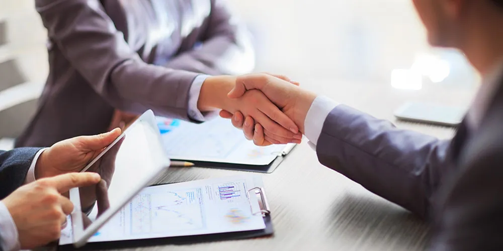 about-us-handshaking Two business people shaking hands