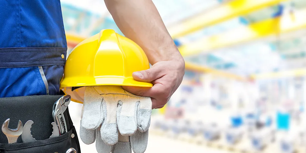 respected-suppliers Workman holding his hardhat and gloves