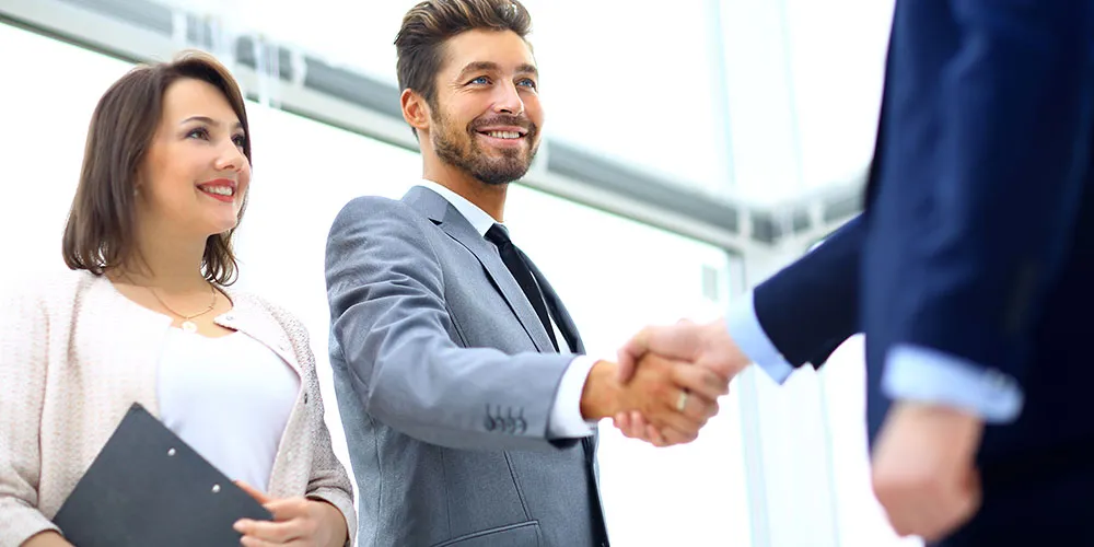 delivering-solutions Customer shaking hands with supplier